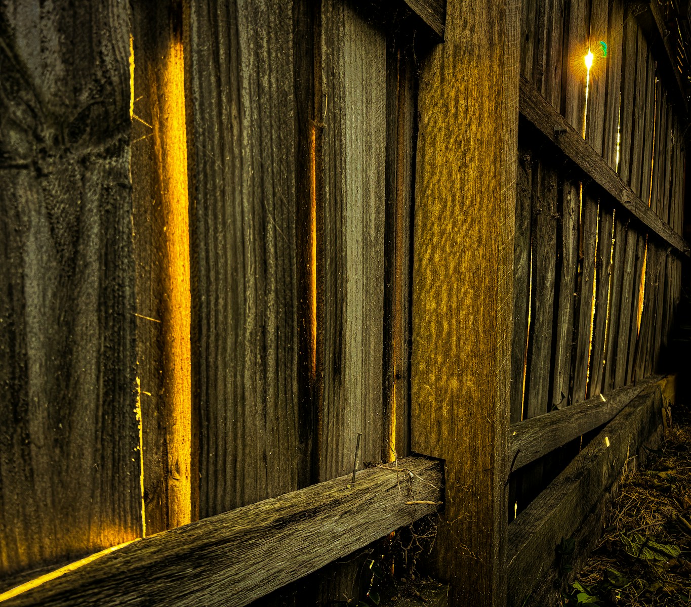 a close up of a wooden fence with a light on